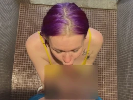 Purple haired chick drops down on her knees to suck a dick