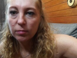 Mature woman penetrates her dripping wet pussy with a gigantic dildo