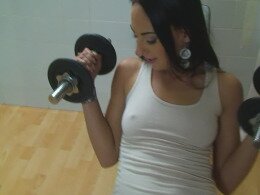 Babe stops her workout session to suck on a dildo