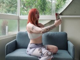 Redhead slut riding a long pecker on the sofa